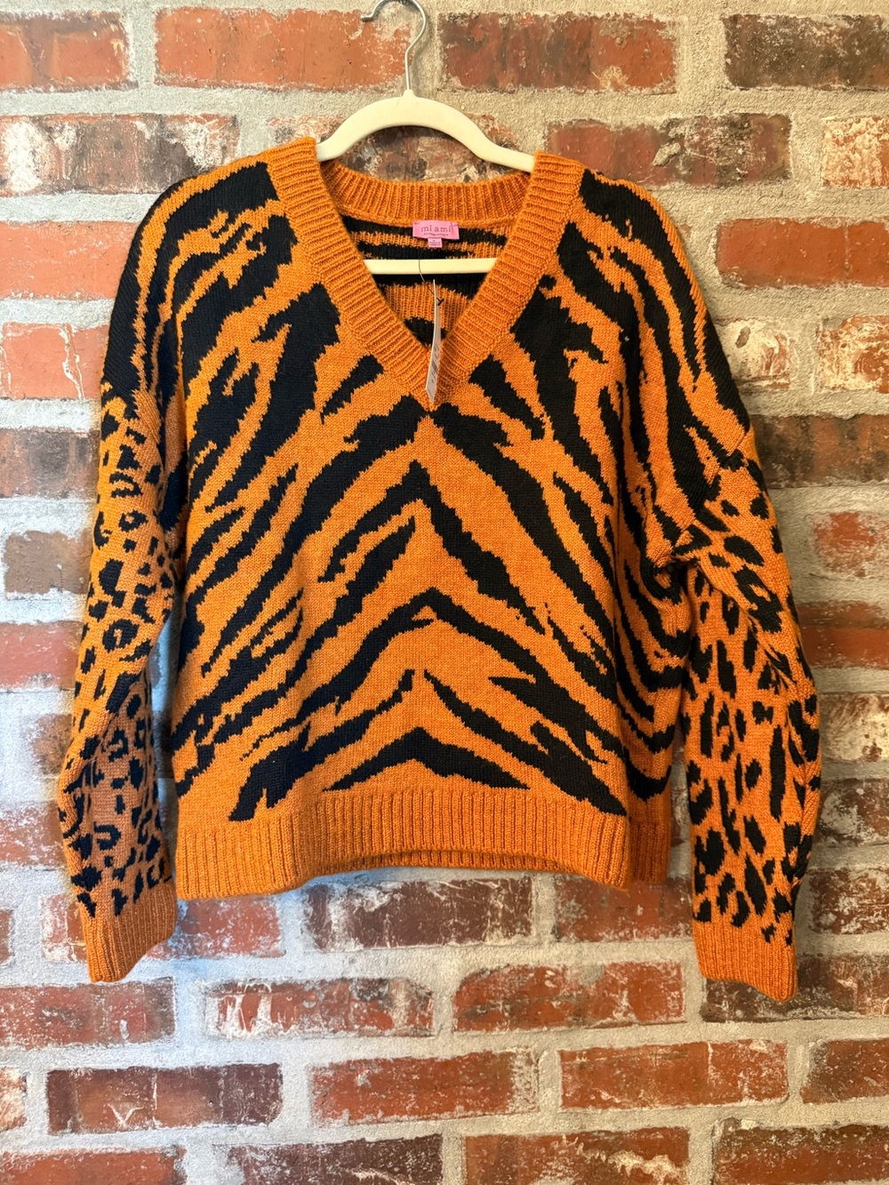 S46 - Francesca's Collections Orange and Black Animal-Print V-Neck Sweater
